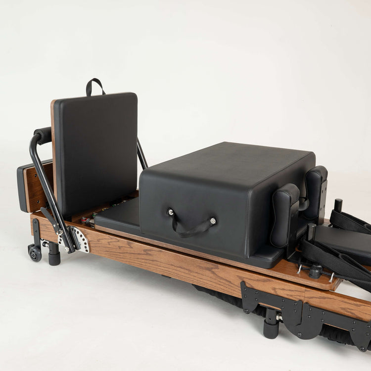 Pilates reformer machine on a white background