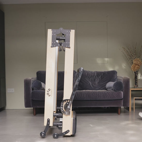 Folded Reformer bed women walking towards the bed in a living room 